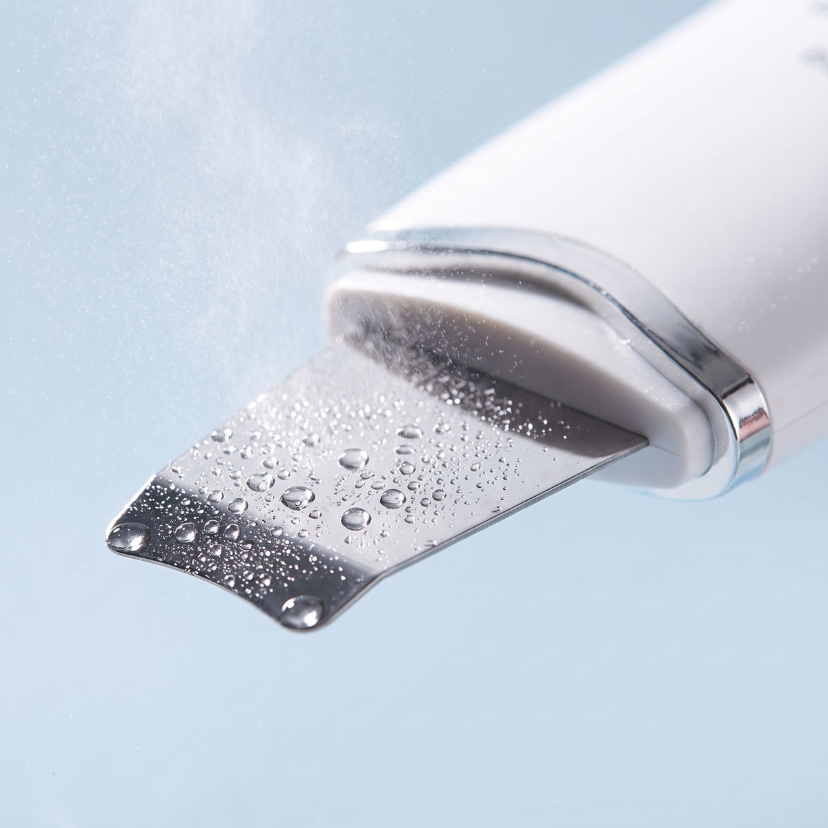 Close-up of the stainless-steel blade of the ultrasonic skin scrubber
