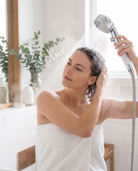 Woman rinsing her hair with the Himra filtered shower head