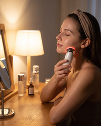 Woman gliding the Himra 7-in-1 glow wand along her jawline