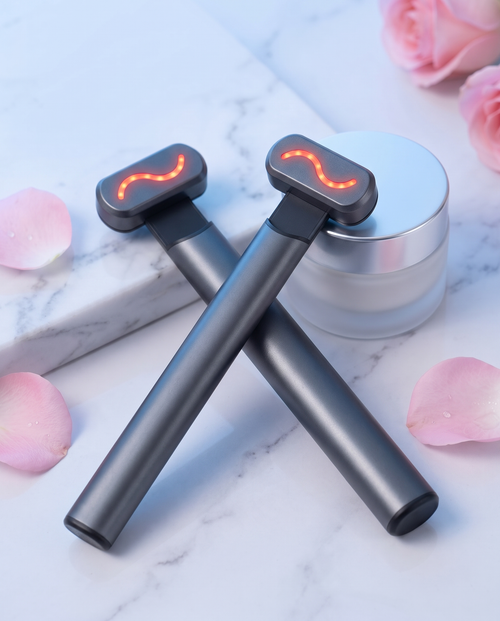 Two Himra warm eye wands with red light on a marble vanity