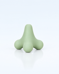Himra trigger point massage ball in sage green on a light blue background