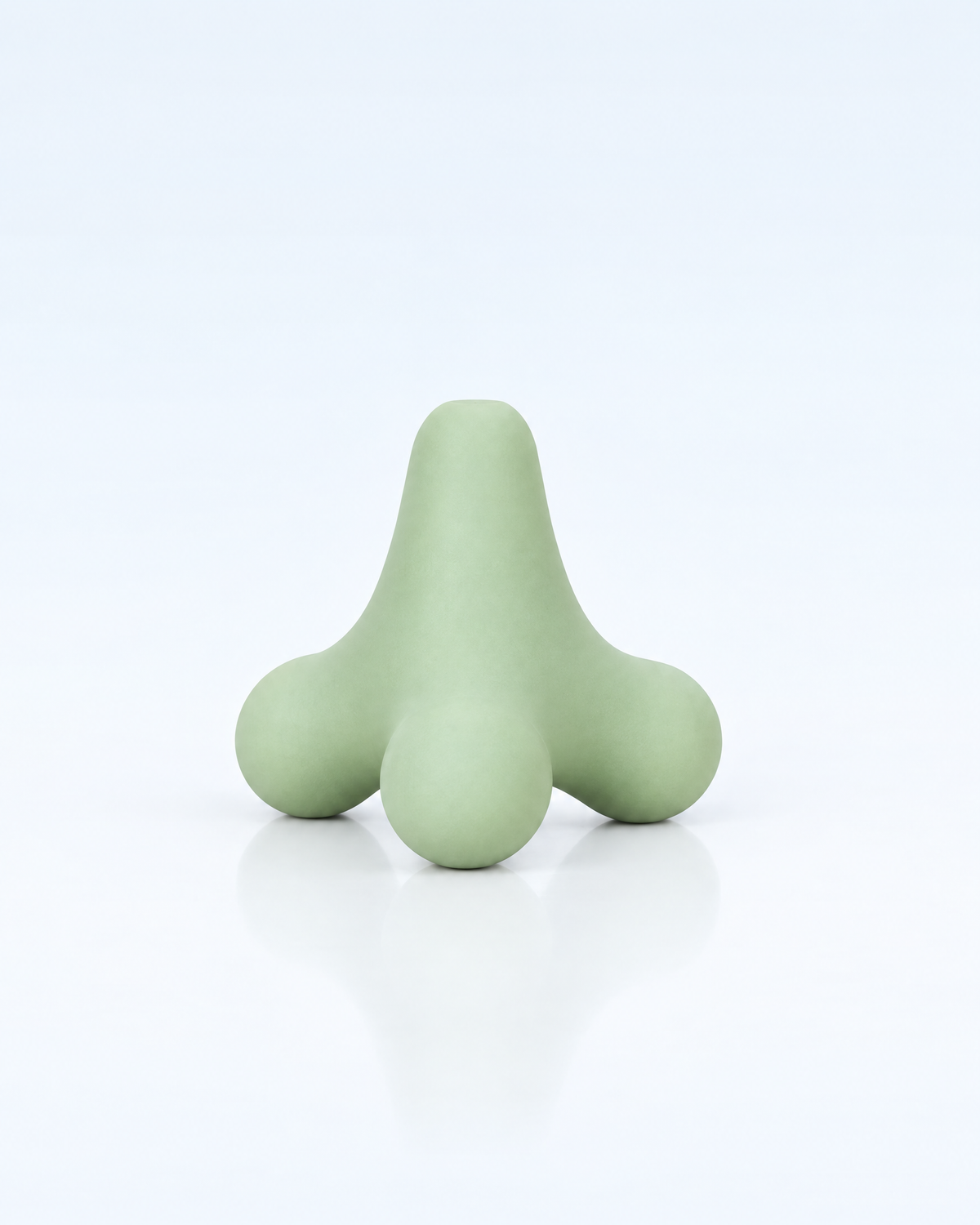 Himra trigger point massage ball in sage green on a light blue background