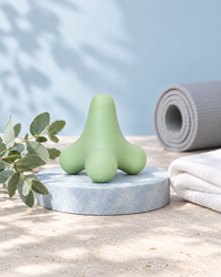 Himra massage ball on a blue stone plinth with eucalyptus