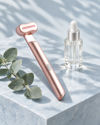The eye wand next to an eye serum