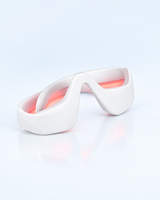 Himra red light eye massager with its light on, on a light blue background
