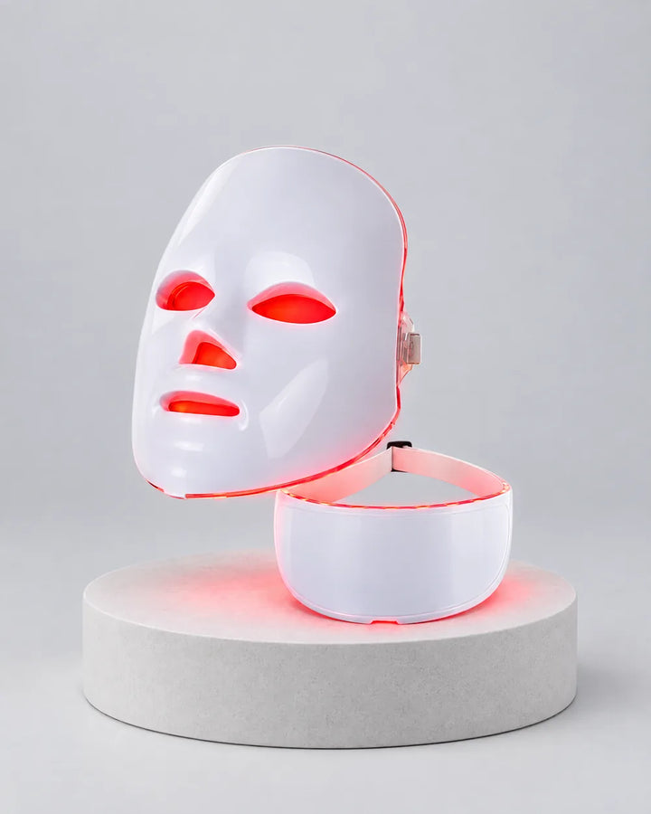 Himra LED face mask and neck piece on a pedestal, lit up