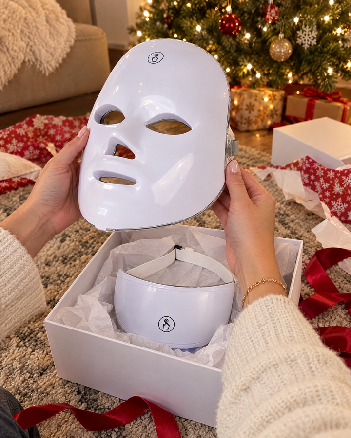 Hands lifting the LED mask out of its gift box