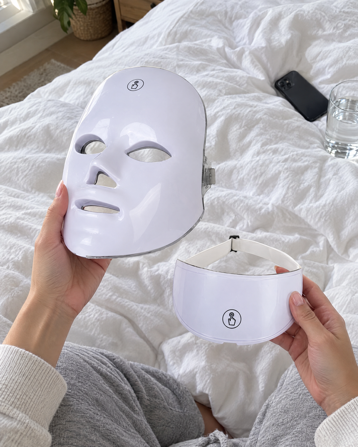 Hands holding the LED face mask and the neck piece