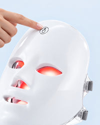 Finger tapping the one-touch button on the Himra LED face mask