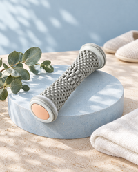 Himra foot roller on a blue stone plinth with eucalyptus and a towel